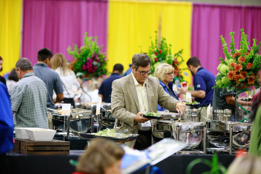 Image of Show patrons eating lunch from buffet stations